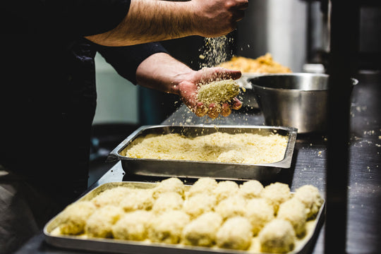 Croquetas recién rebozadas, enrolladas a mano
